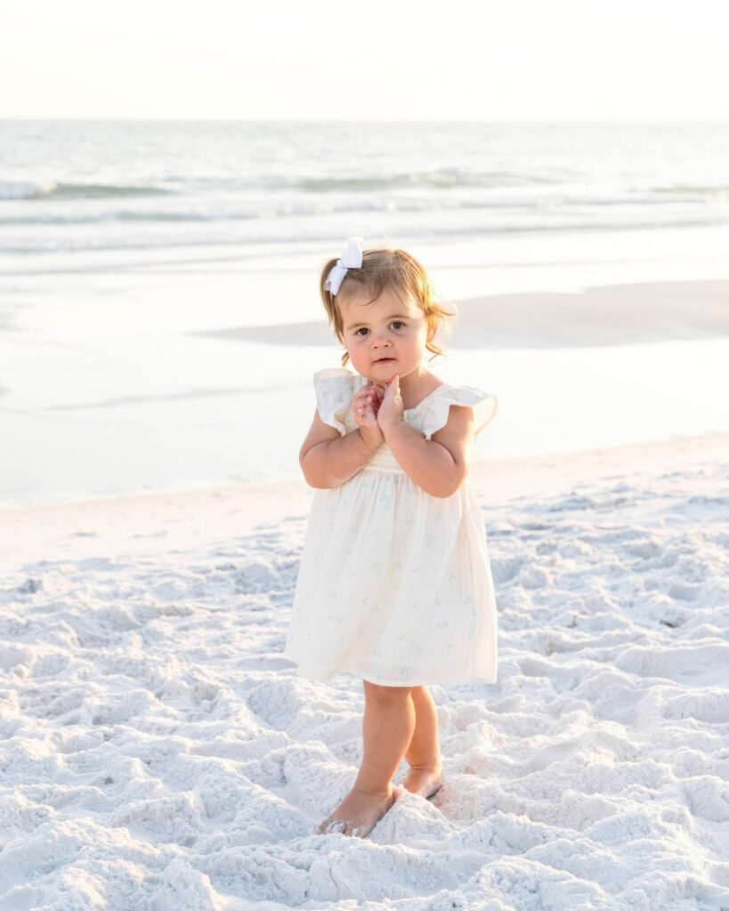 Young toddler standing on the beach during a 30A extended family photography session.