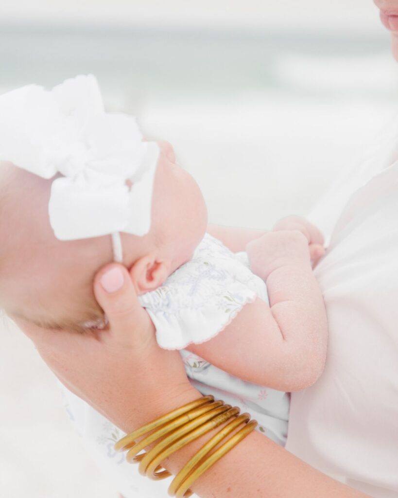 Parents welcoming a new baby during a Destin Florida beach family session