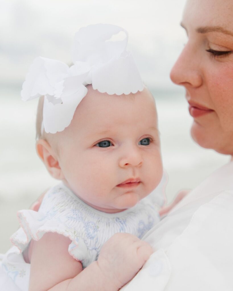 Mother and newborn baby girl photographed at The Henderson Resort beach in Destin