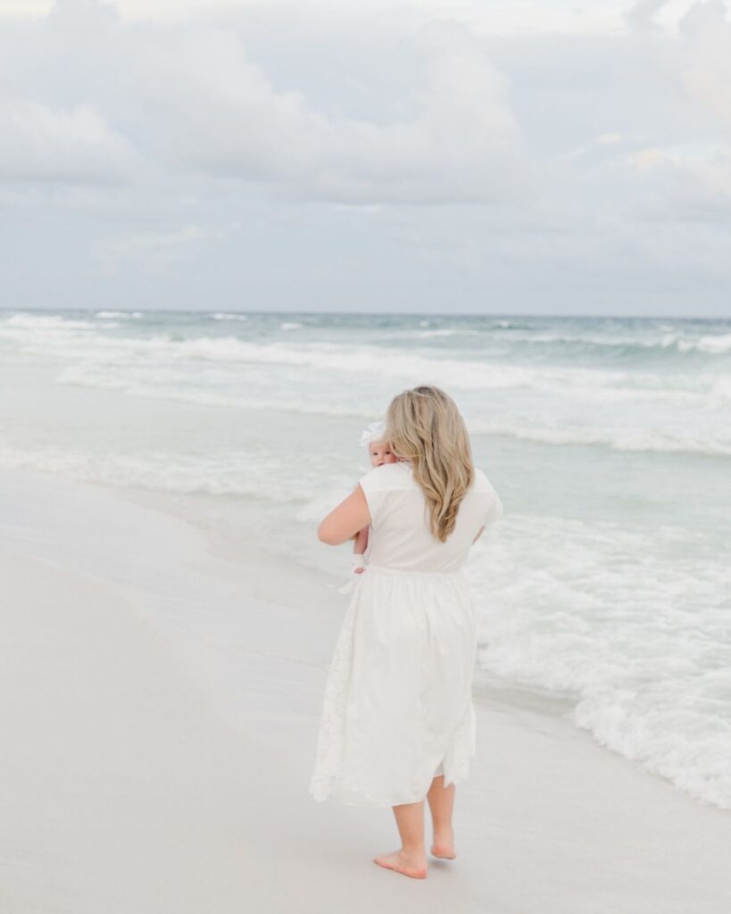 Mother and newborn baby girl photographed at The Henderson Resort beach in Destin