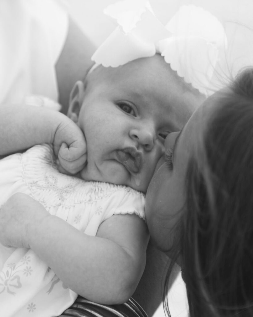Family of five gathered together on the shoreline at The Henderson in Destin