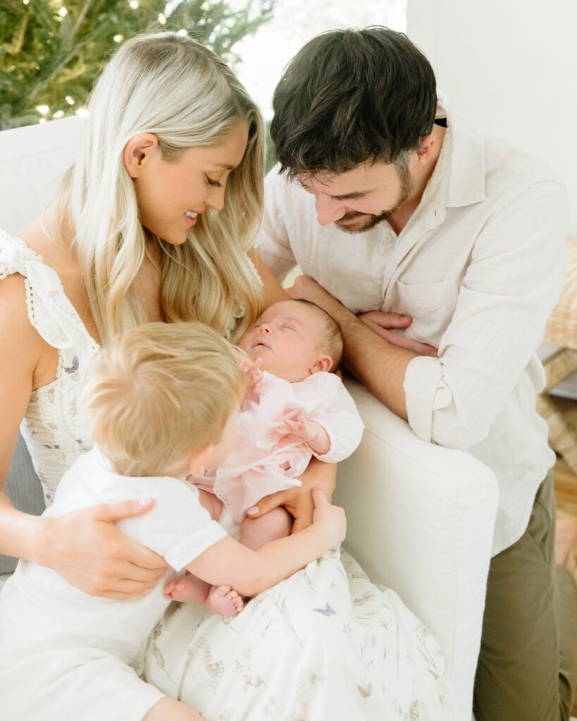 Family of four during an in-home lifestyle newborn session in Santa Rosa Beach Florida