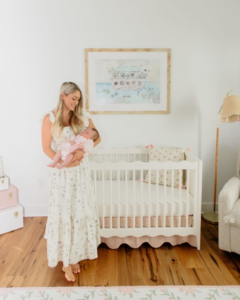 Mother holding newborn during an in-home lifestyle newborn session in Santa Rosa Beach Florida