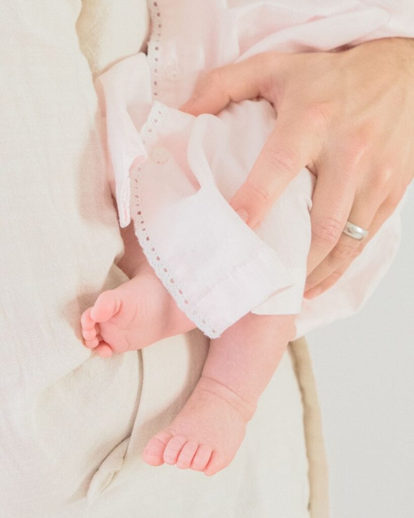 Father holding newborn during an in-home lifestyle newborn session in Santa Rosa Beach Florida