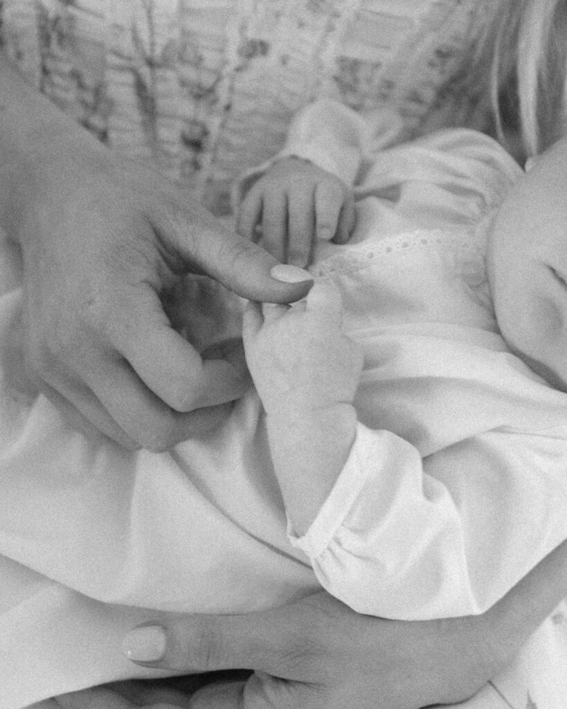 Mother holding newborn during an in-home lifestyle newborn session in Santa Rosa Beach Florida