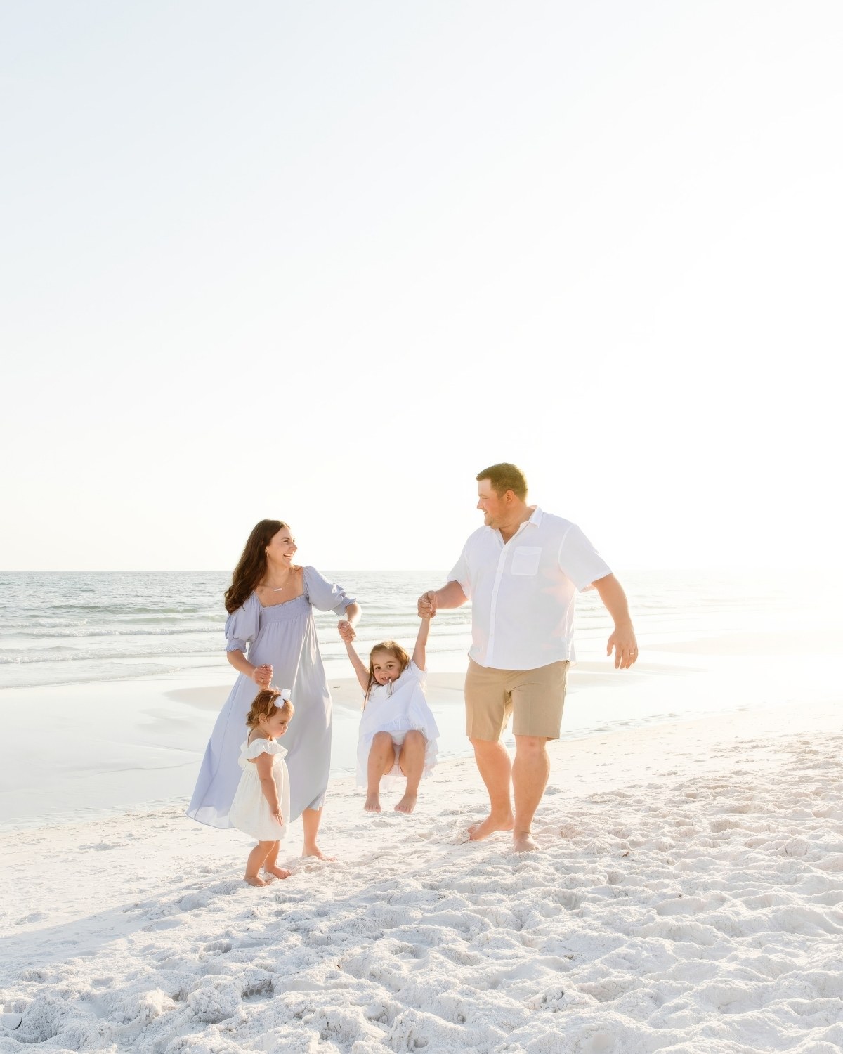 Family walking together along the shoreline during a 30A extended family beach photography session.